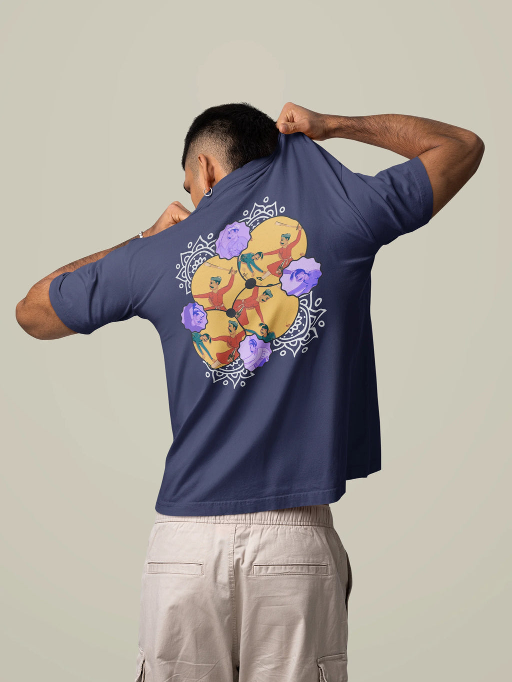 Person wearing a navy blue t-shirt with a colorful graphic design on the back, standing against a plain background.